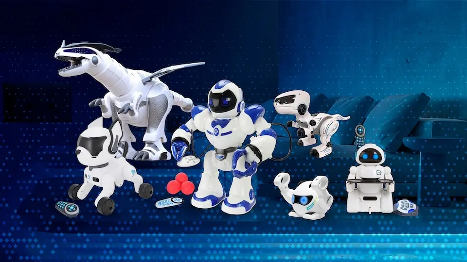 Vários brinquedos robóticos brancos e azuis dispostos sobre fundo azul, incluindo um robô humanoide, um dinossauro robótico, rovers, controles remotos e três bolinhas vermelhas