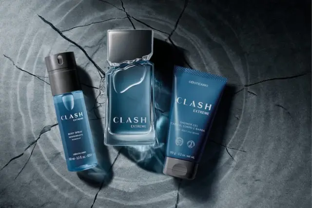 frasco de Clash Extreme entre body spray e shower gel sobre superfície escura com rachaduras e ondas concêntricas