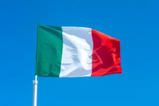 Bandeira da Itália tremulando em mastro contra céu azul